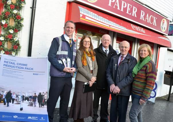 The scene in Ahoghill village last week where folks came together to launch the Ballymena Retail Crime Reduction Pack. Included is Chairperson of Ballymena PCSP Councillor Roy Gillespie and Karen Moore, PCSP manager. INBT 49-802H