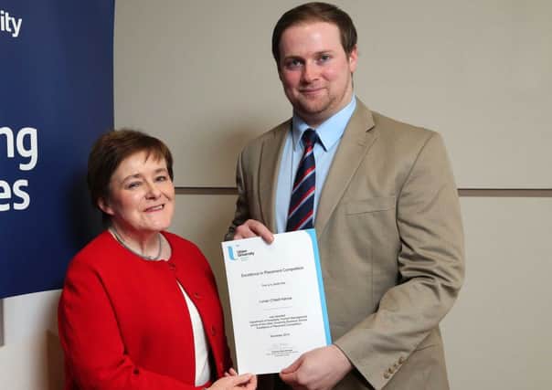 Lonan O'Neill, from Portstewart, is presented with his Ulster University Business School Excellence in Placement Award by the Dean, Professor Marie McHugh.