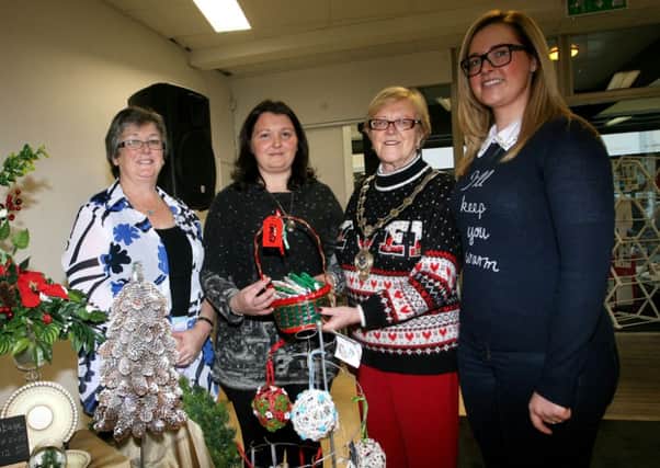 Mayor of Ballymena, Cllr. Audrey Wales, who officially opened the Ballymena Christmas Markets is pictured along with Grace Carmichael (BIDS project officer), and Bridget Turtle and Moya Johnston of Bettys Blooms. INBT49-201AC