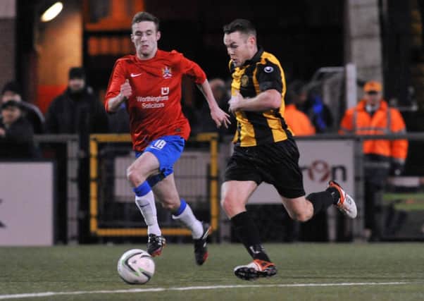 Ards' Gary Warwick tracks Carrick's Aaron Harmon durng the semi-final at Seaview on Friday evening. Picture: Presseye