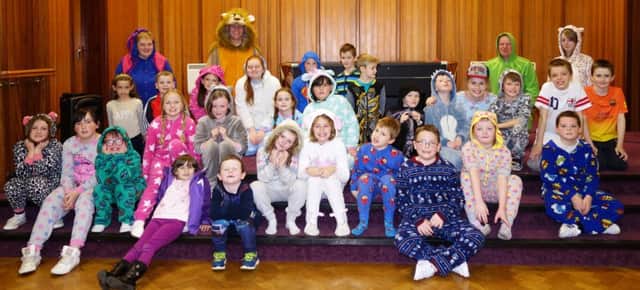 Pastor Jonathan Payne pictured with children from Kidzone and their leaders at the Onesie night in Ballymoney Church of God. inbm49-14s
