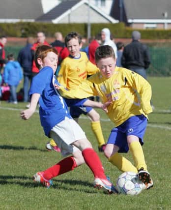 Banbridge Rangers' Chris Oakes and Dungannon United Youth's Oisin O'Donnell battle for possession during the  MId Ulster Youth League Under 12 Knock Out Cup Final at The Gordon Playing Fields. RicPics. 20/4/13.