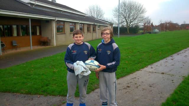 Ballymoney U14s youth players Gary Brennan (left) and Caleb Bartlett (right) who were invited by the senior team to be ball boys at Saturday's home match between Ballymoney 1st XV and Bangor.