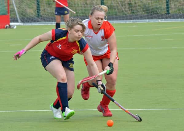 Jade Purdy of Ballyclare Ladies and Michelle Finlay of Larne Ladies chase the ball in their game at Greenland. INLT 16-004-PSN