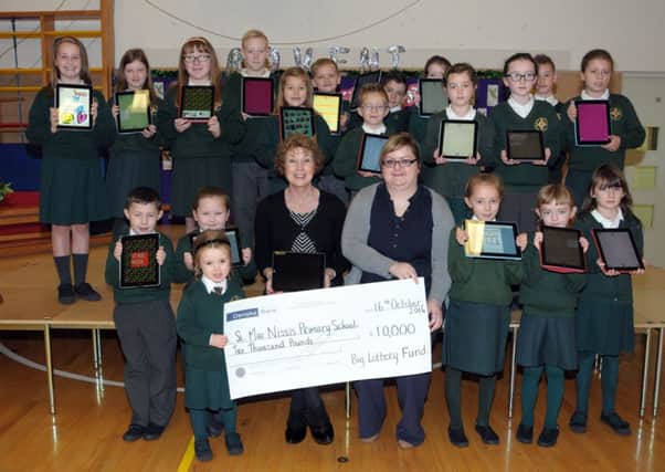 St. MacNissi's PS principal, Mrs brady and staff and pupils with some of the equipment bought with their £10,000 award from The big Lottery Fund INLT 49-205-AM