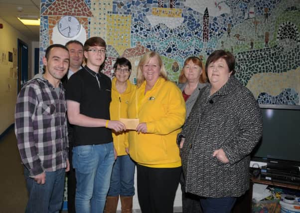 Trevor Robinson, a leader at Larne YMCA presents a £147.50p Cheque to Mandy Ferguson from Kaleidescope NI, Trevor raised the money by running The Larne Half Marathon, also pictured are, Dean Nutt, Mark McCormick, Mandy Hogg ,Shirley Greenlees and Louise robinson, Trevors Mum INLT 49-201-AM