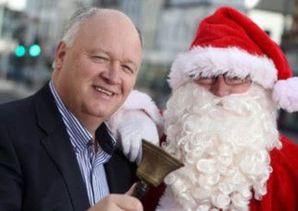 David Simpson gets set for his annual sit-out with encouragement from Santa Claus.