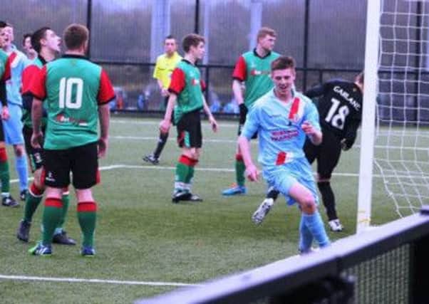 Josh Corry wheels away in delight after scoring for Ballymena United Youth in their game against Glentoran.
