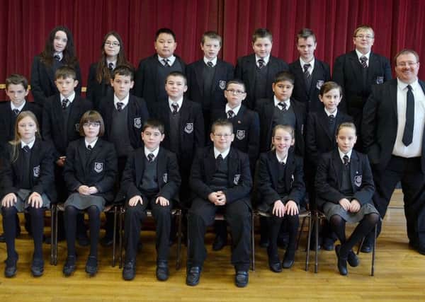 The new Year 8A3 class with teacher Mr McVeigh of Cullybackey College. INBT 47-803H