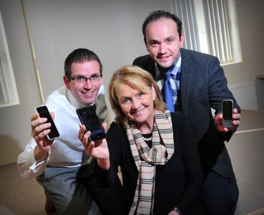 Charis Cancer Care Patron Jenny Bristow with James Graham Senior Agent NFU Magherafelt and Derek Scott Junior Agent NFU Magherafelt with their mobile phones at ready to vote for CHARIS New Ways of Thinking between 9am and Midnight on Monday the 24th of November when the NFU Magherafelt officially launched their cookery demonstration night featuring Jenny to be held at Curragh Hall Maghera on Wednesday the 10th of December.INMM4714-376