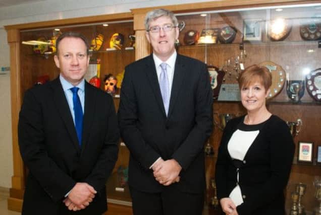 Education Minister John O'Dowd with Carrickfergus College principal Hedley Webb and vice-principal Amanda Irvine. INCT 50-750-CON