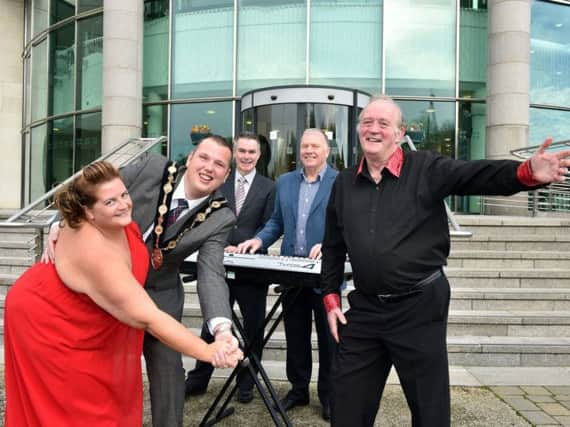 Pictured at Lagan Valley Island to launch the forthcoming Christmas Tea Dance are: (l-r) Rith Stewart, Dance Amore; the Mayor of Lisburn, Councillor Andrew Ewing; Jeff Scroggie, Health Development Specialist, SEHSCT; Housty, musician and Cecil McCune, Dance Amore.