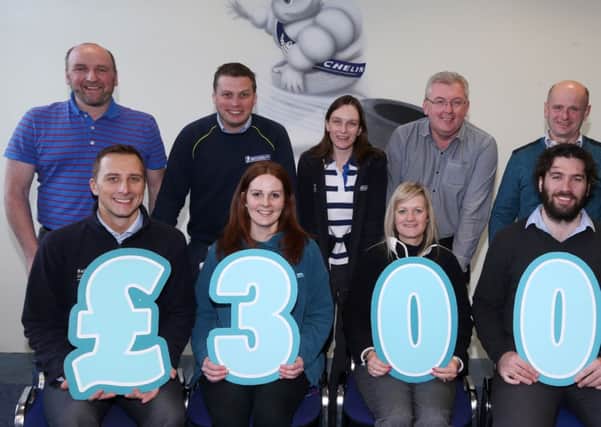 Michelin staff who presented £3000 to Cancer Focus Health Promotion Officer Stephanie Allen after a fund raising campaign  at the factory during September. Back, L-R, James Black, Stephen Hamill, Heather Dale, Jimmy Fenton, John McCloy. Front, L-R, Chris Daniels, Stephanie Allen, Cathy Simpson (Personnel Manager), Joel Andrews. INBT 50-105JC