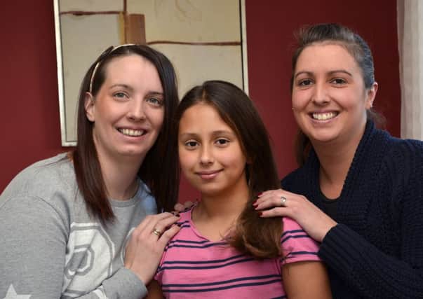 Amelia Shipley, centre, who will be having her hair cut at Oakgrove Integrated Primary School today (Wednesday) to raise funds for the Little Princess Trust. Included are Sonia Ratcliffe, left, and Rachel Shipley. Amelia's hair will be used to make a wig for a child who has lost their hair whilst undergoing treatment for cancer. INLS4914-187KM