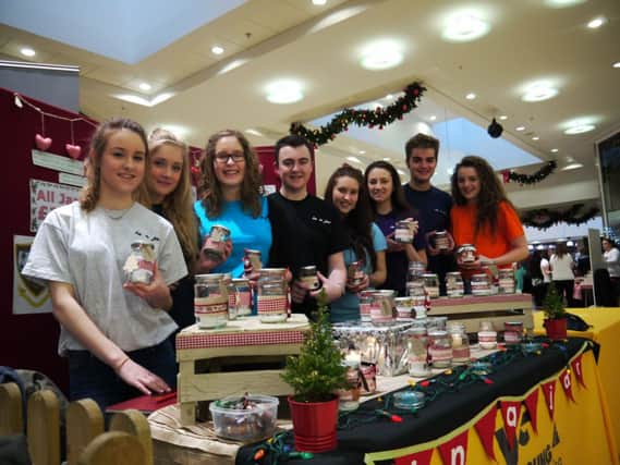 Young Enterprise students Sarah Crossey, Katie Pierce, Cait Kirkpatrick, Lewis Dobbins, Oonagh Jordan, Ellen Reid, Andrew King and Alice Coulter from Dalriada School show off their products at the Young Enterprise Trade Fair at the Tower Centre Ballymena on Wednesday 3rd December 2014. INBM50-14S