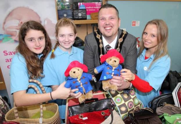 Mayor Andrew Ewing with Olivia Mallon, Ellie Nicol and Patrycja Paszewsha at the Christmas Fair at Hillsborough Village Centre. The fair helped raise funds for SSAFA and Action Medical Research. US1449-526cd  Picture: Cliff Donaldson