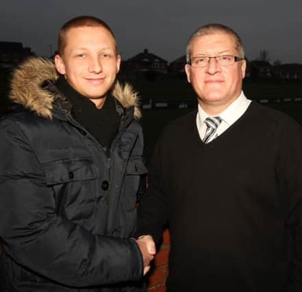 Lisburn Distillery manager Tommy Kincaid welcomes new signing Kevin Short to the Whites after the away game at Wilgar Park on Saturday. Picture - David Hunter.