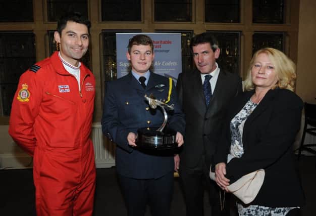 Michael receiving his Trophy from Red One, Sqn Ldr David Monty Montenegro, watched by his parents Nigel and Wendy; and tv presenter James May looking envious of Michaels newly-presented award.