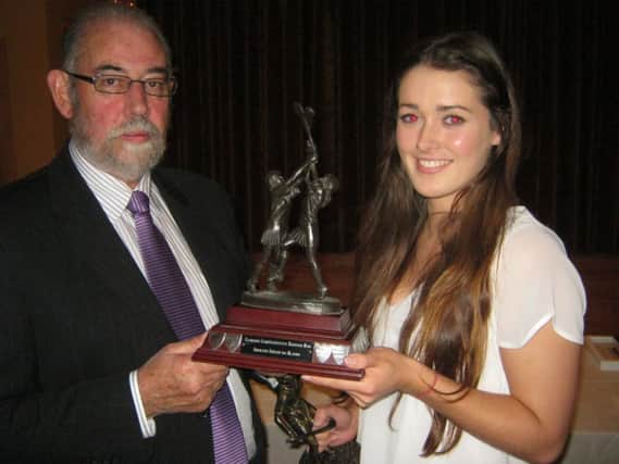 Senior Camog of the Year, Megan Kerr, receives her award from Brian Smith. (s)