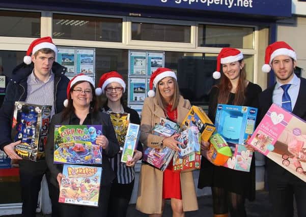 Kate Peden and staff with some of the donations for the Cash for Kids Appeal.