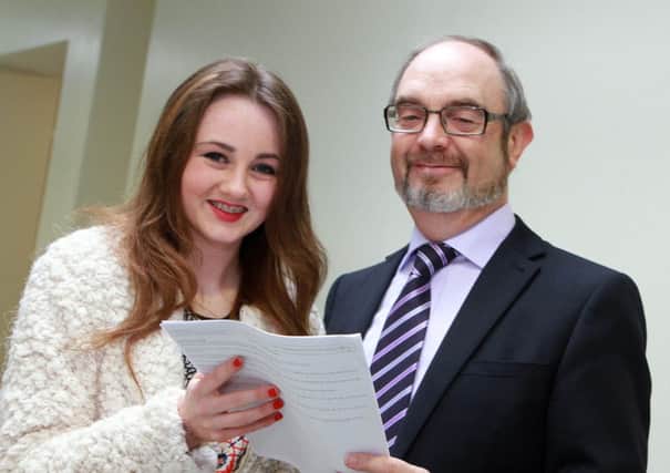 Lumen Christi College principal, Mr. Patrick ODoherty, with college student Eva Kerr, who collected 12A*, from her GCSE results. 3414-0029MT.