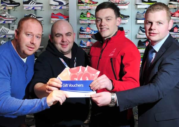 Gerard McSloy Manager of McConnell's Intersport Cookstown hands over the Mid-Ulster Mail & Tyrone Times Sports Personality for the month of November winning vouchers to Sperrin Harriers member Gavin Corey. Included in the picture are Patrick Cullen Mid-Ulster Mail & Tyrone Times Advertising Team Leader and Dominic Kelly (Ulster Bank).INTT5014-353