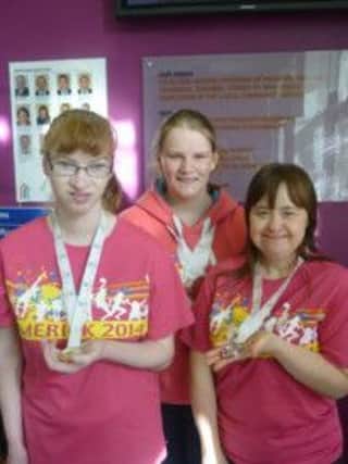SRC students Jill Connery, Rebecca Devlin and Denise Fegan with their medals from the Special Olympics.