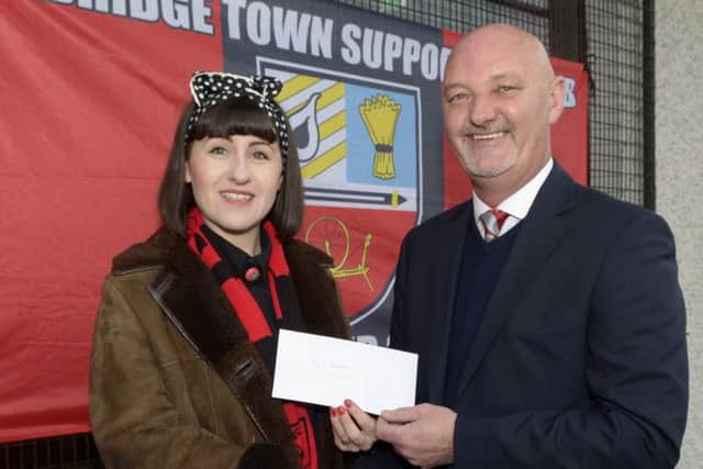 Banbridge Town Chairman Stephen Radcliffe accepted a donation on behalf of player Damian McParland who has been out of the game due to an injury, from Banbridge Town Supporters Club Chair Julie Comiskey ©Paul Byrne Photography INBL1449-228PB