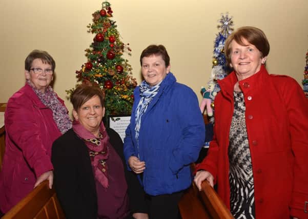 Valerie Moore, second from left, pictured beside the Christmas tree titled â¬ÜFruits of the Earthâ¬" which she created in memory of the parents, Bobby and Lizzie Kelly, for the Festival of Trees in Dunnalong Parish Church, Bready. Included are, from left, Irene Faulkner, Joan Cole and Carol Wray. INLS4914-193KM