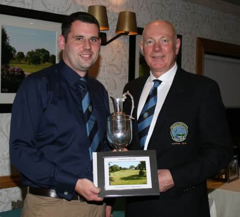 Adam Foreman picks up the Club Championship Trophy from the Gents Captain.