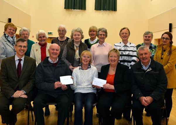 Doreen Mairs, Chairperson of Gracehill Country Markets, presents cheques to Alex McDonald (St. Vincent de Paul) and Rev. Sarah Groves (Gracehill Moravian Church) are pictured receiving cheques from Doreen Mairs (Chairperson) of Gracehill Country Markets, money raised by the local group at the Moravian Church Hall. INBT50-249AC