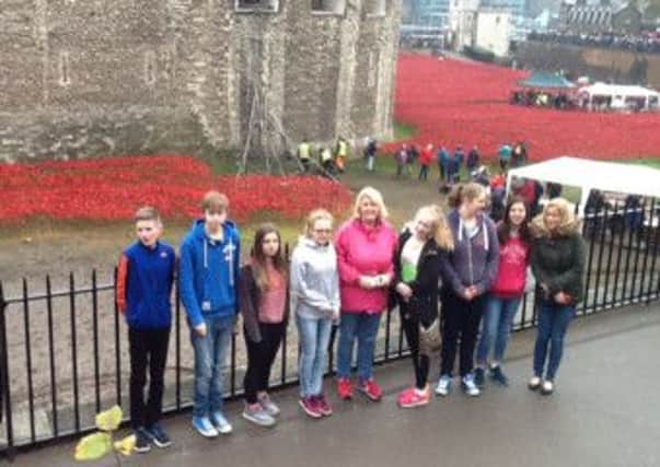 Some of the young delegates at the Blood Swept Lands and Seas of Red poppy exhibit at the Tower of London.