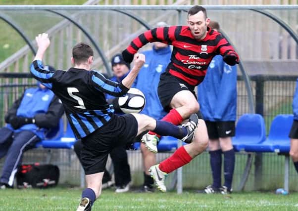Newtowne FC captain Paul McIvor gets caught in a very high tackle by Crumlin United's Brendan Dorrian during their Irish Cup 4th round match on Saturday. Dorrian got sent off for the challenge. INLV4914-283KDR