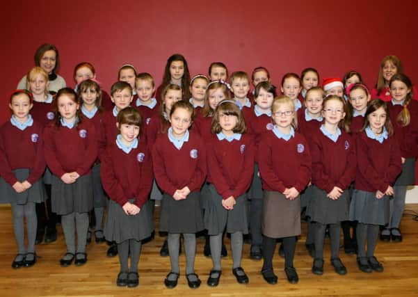 Mrs. C. Fisher and Miss N. Moore with the Kells and Connor PS choir who sang at the Kells and Connor Senior Citizens annual Christmas dinner. INBT50-205AC