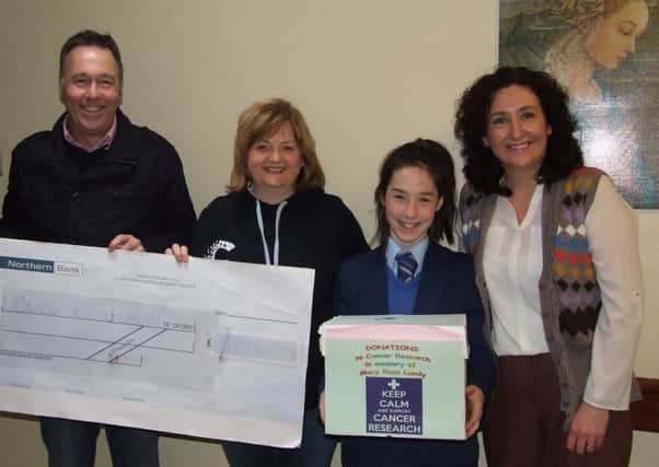 Loreto College student Sarah Lundy presents Sharon Arbuckle of Cancer Research NI with a cheque for £1195.  Also pictured are Mr Ronan Lundy and Mrs Lorraine McCool, Social Justice Co-ordinator at Loreto College.