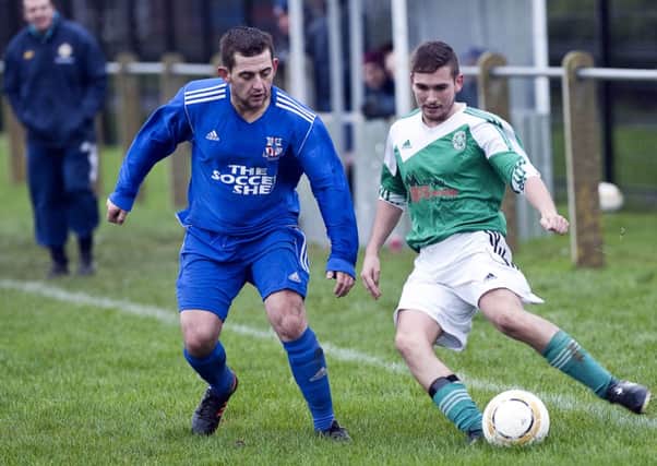 Rathfern's hat-trick man Gary Orr keeps a close watch on St Patrick's YM's Conor Alsop. Photo: Philip McCloy