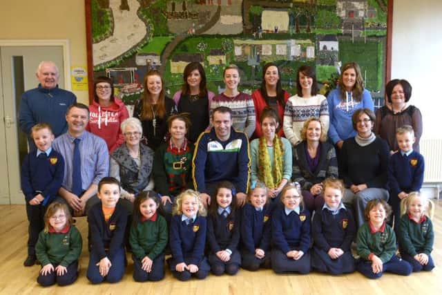 Principal Kevin Donaghy (seated left at front) and the Staff of St Colman's Primary School Annaclone with representatives of the pupils and All Saints Nursery are celebrating receiving the UK Standard Inclusion Quality Mark  ©Edward Byrne Photography INBL1450-257EB