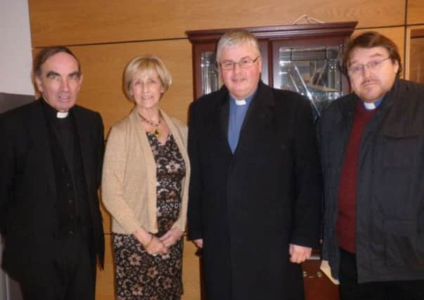 Violet Phillips of Maghera Cancer Research Committee with local Clergy at the Carol Service in St Lurach's Church.