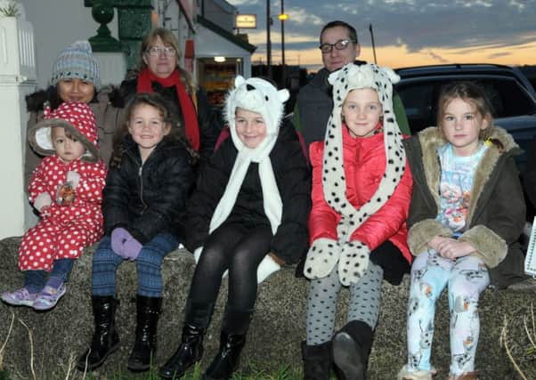 These youngster,s found a ringside seat at Islandmagee for the switch on of the Christmas Tree lights INLT 50-227-AM