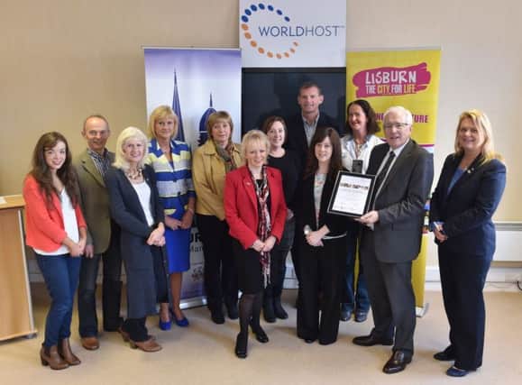 Representatives of local businesses pictured with Alderman Allan Ewart, Chairman of the Council's Economic Development Committee at an event where they received their WorldHost certificates.
