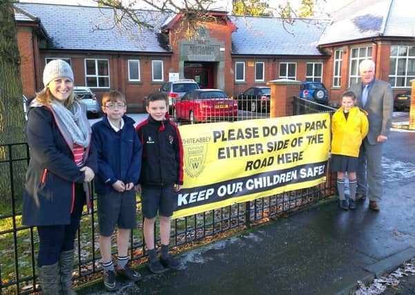 Catherine Johnson, parent governor, and principal Peter Wright were joined by pupils Jacob Greer, Jamie Thompson and Sabriel Gergett to urge motorists driving or parking in the vicinity of Whiteabbey Primary School to think about the safety of pedestrians, particularly children. Banners carrying the road safety message, printed by one of the parents in support of the new campaign, have been erected at the entrance to the school. INNT 51-506CON