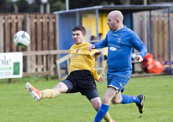 UUJ's Michael Donnelly clears the danger from Lisburn Rangers' Darren McCall. INLT 51-902-CON Photo: Philip McCloy
