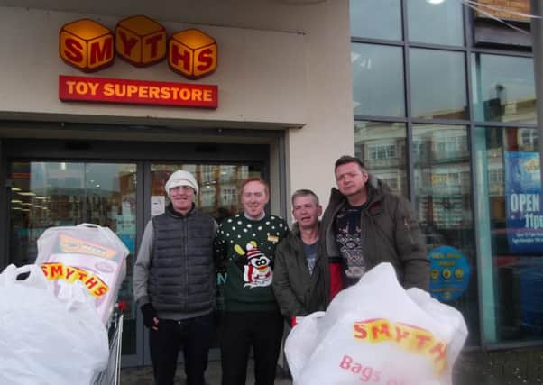 Members of the Corinthians Darts team with Ruairi Morris, manager, at Smyth's toy store, picking up some gifts for the Altnagelvin Children's Ward.