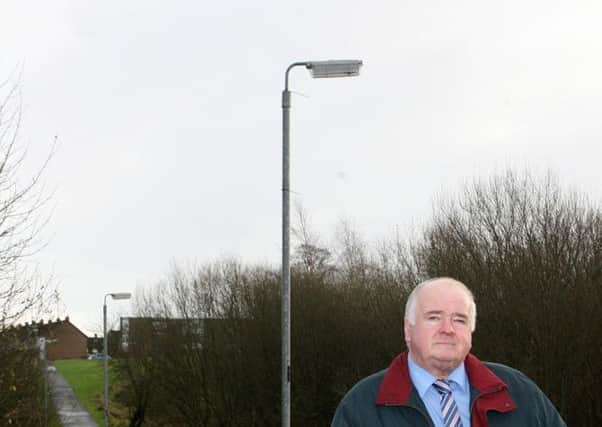 Cllr. Martin Clarke at the Ballykeel bridge where the street lights have now been repaired. INBT51-220AC