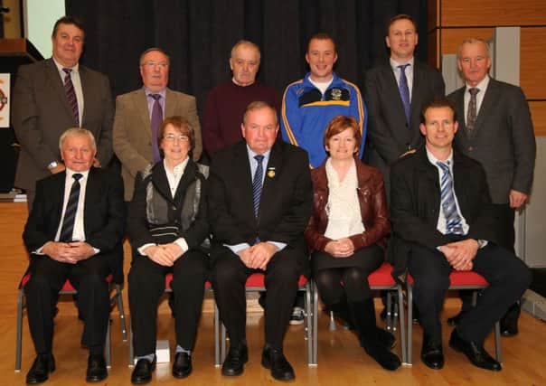 Book Committee with guests. Back row: County Chairman Jim Murray, Danny McLernon, Anthony McMullan, Paul Hasson, Ulster Cultural Officer Donal McAnallen and Michael Hasson. Front row: Jim Smyth, Mary K McMullan, Uachtarán Liam ONeill, Rosemary McMullan and Club Chairman Michael Hardy. INBM51-14