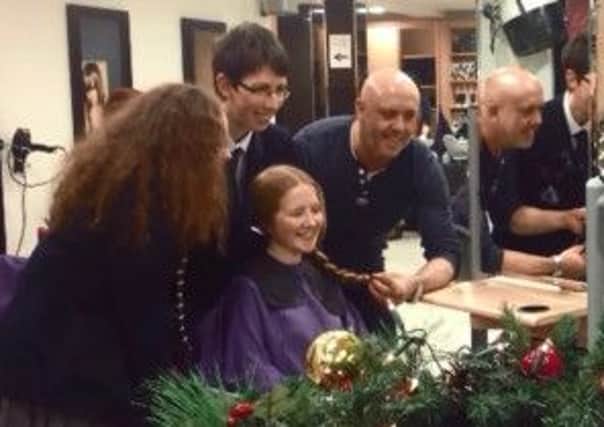 Lauren Brennan getting her hair cut for charity.