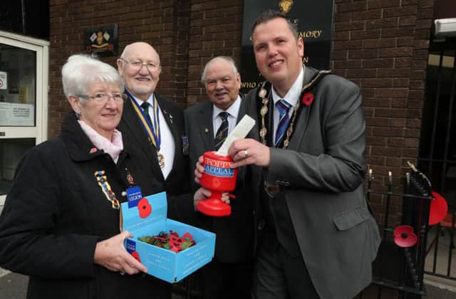 Pictured with the Mayor of Lisburn, Councillor Andrew Ewing as he buys the first poppy are: (l-r) Anne Hood, President of the RBL Women's Section; John Jamieson, Royal British Legion (Lisburn Branch) and Ivan McCammon, Royal British Legion (Lisburn Branch)