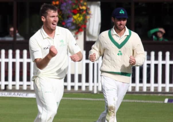 Coleraine's new signing Graeme McCarter celebrates taking a wicket for Ireland.