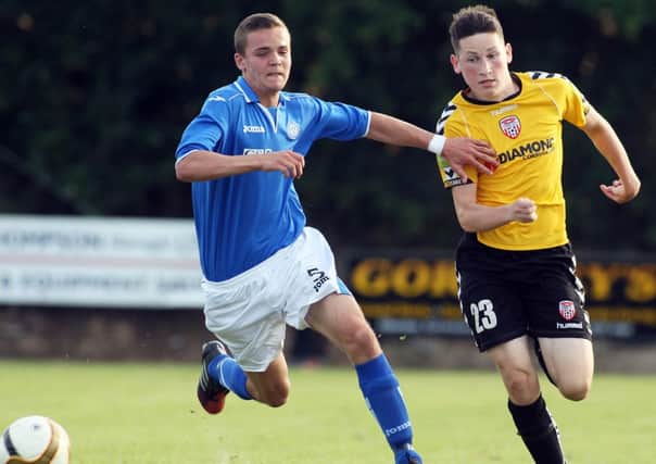 Derry Citys Conor McDermott tries to get away from St. Johnstones Gregor Munro, during last years Under 17 final.
