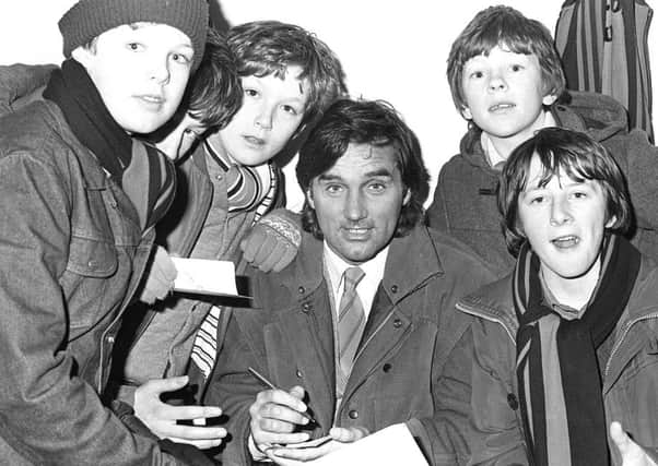 George Best arriving at Tobermore United F.C for game against Ballymena United which was cancelled for the second time because of waterlogged pitch.  Pacemaker Press Intl. 1/2/84.

71/84/BW